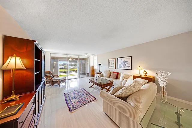 a living room with furniture a rug and a window