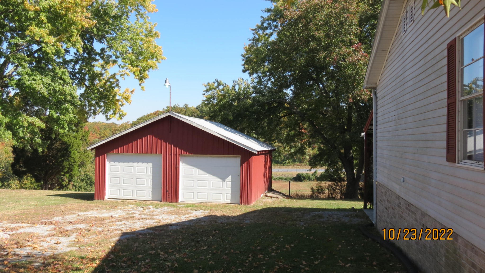 2046 Old Snow Hill Road Dowelltown, TN 37059 - Photo 6 of 34 a front view of a house with a yard and garage
