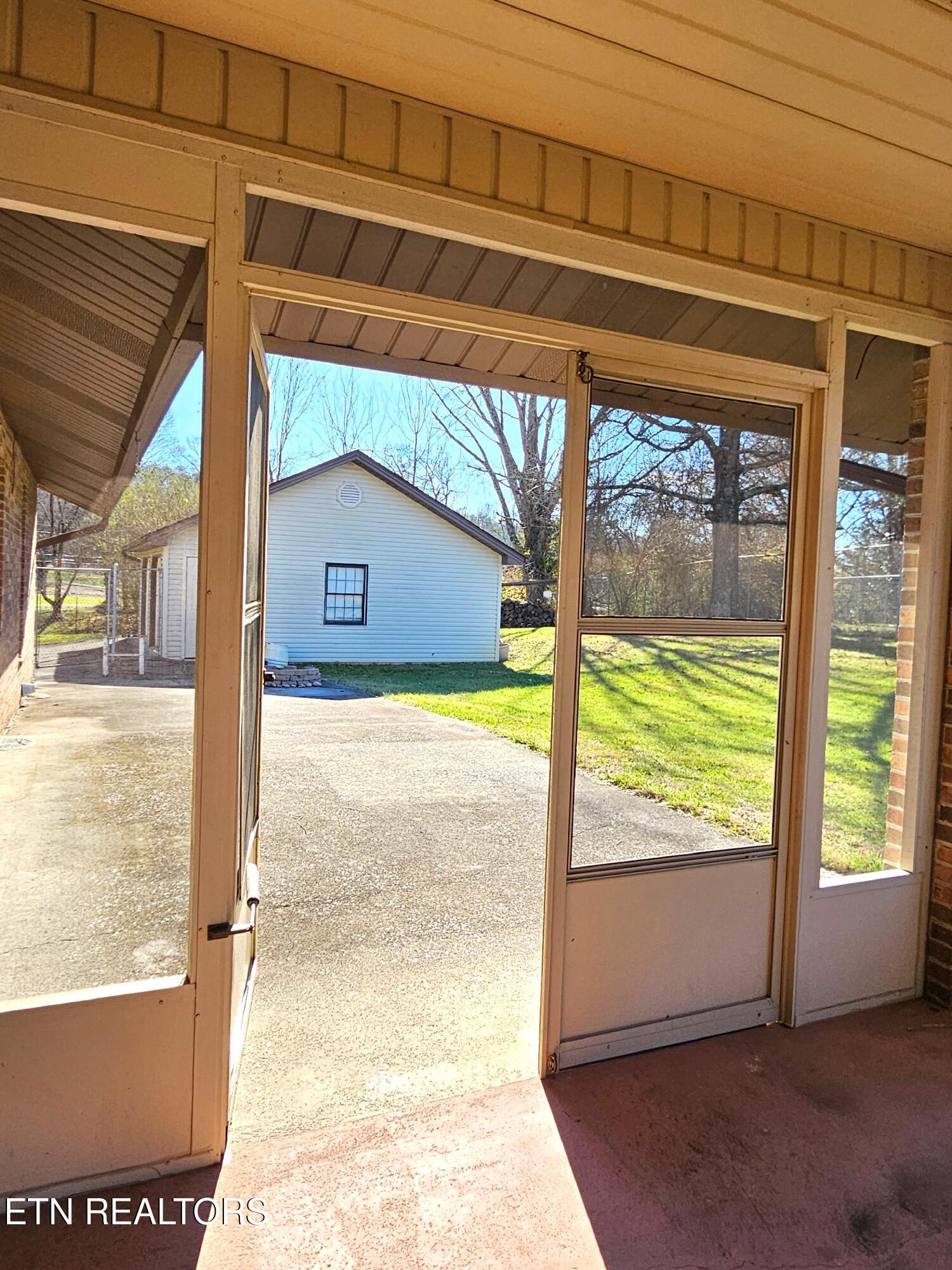 9430 North Ruggles Ferry Pike Strawberry Plains, TN 37871 - Photo 24 of 27 Double door from screened porch to patio