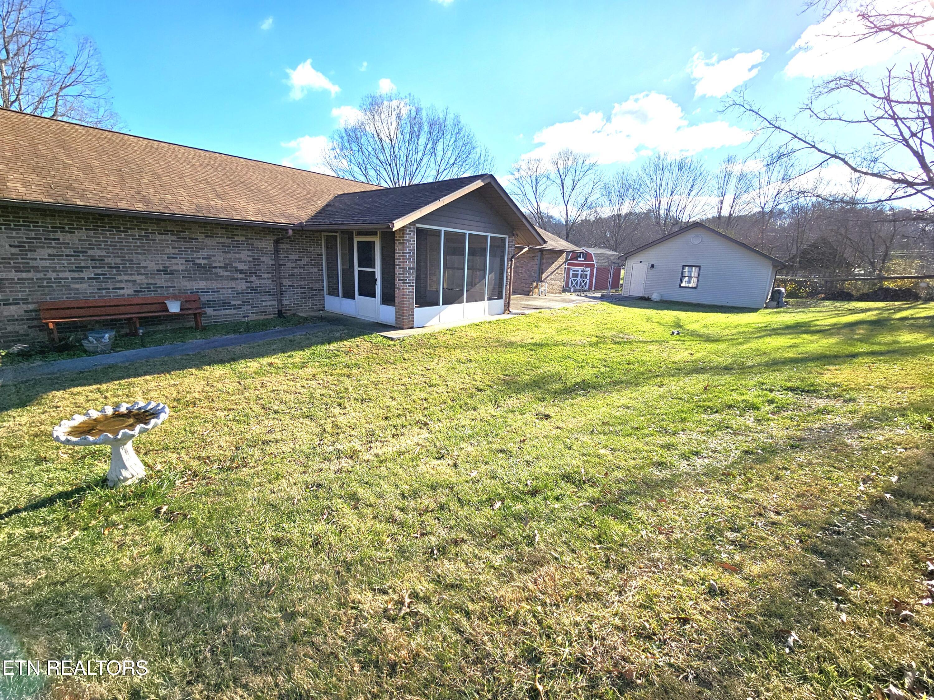 9430 North Ruggles Ferry Pike Strawberry Plains, TN 37871 - Photo 27 of 27 Ruggles Ferry backyard toward screened p