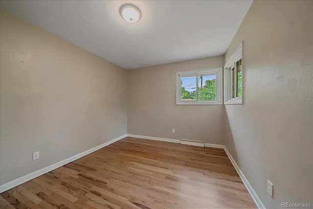 wooden floor in an empty room with a window