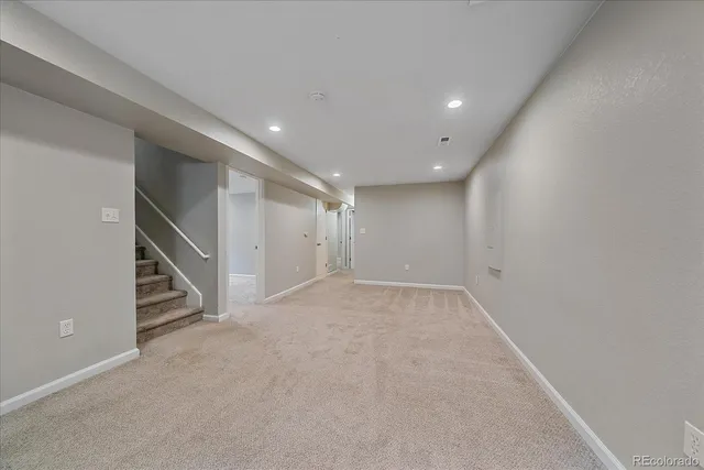 a view of an empty room with stairs