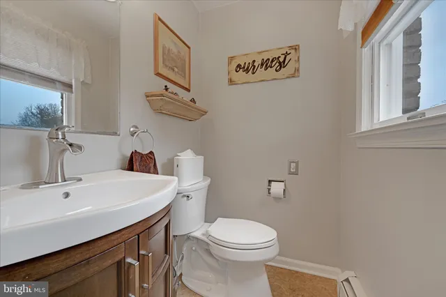 a bathroom with a sink a toilet and a mirror