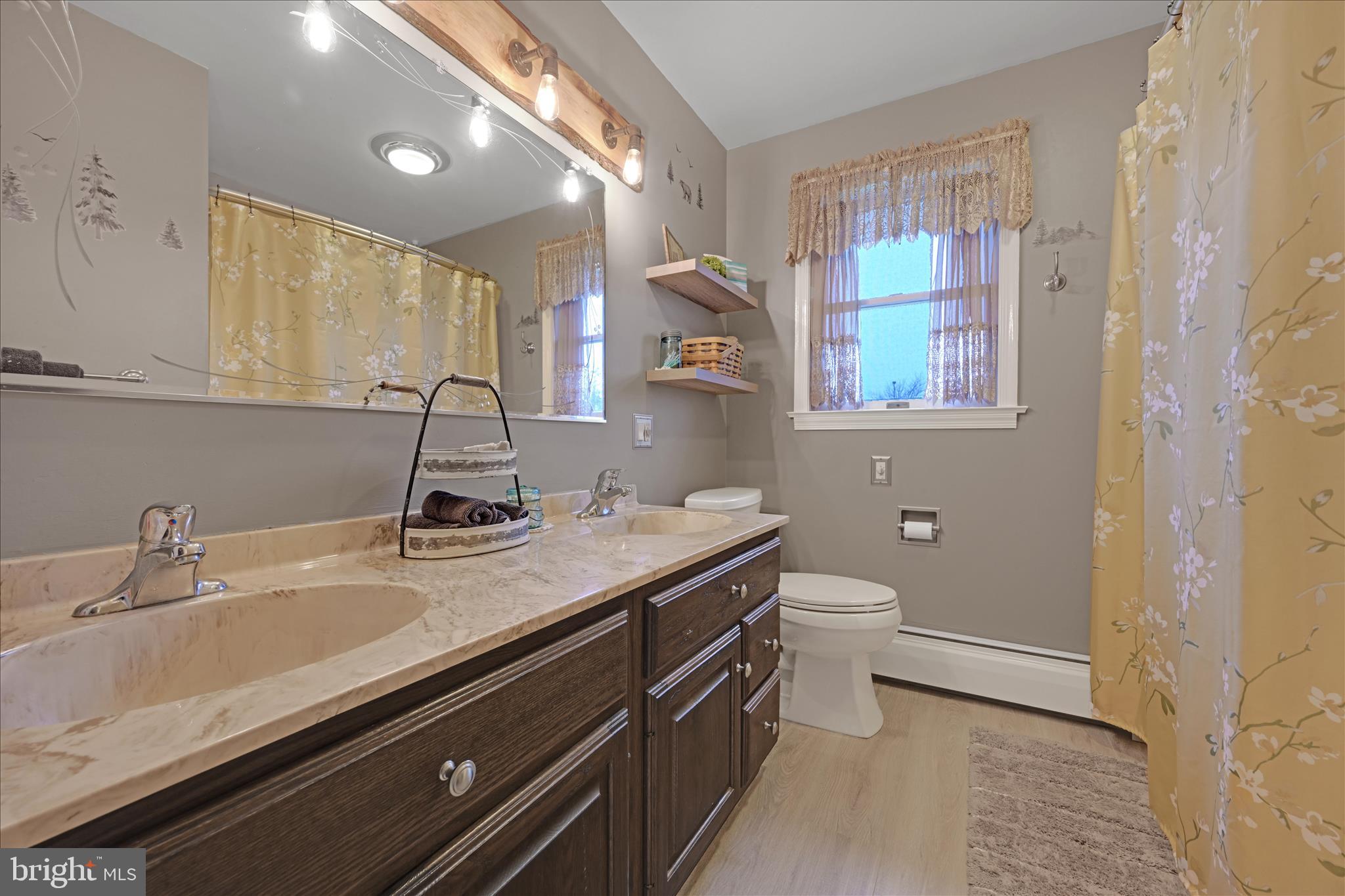 460 Shirksville Road Jonestown, PA 17038 - Photo 25 of 42 a bathroom with a granite countertop sink a toilet and a mirror