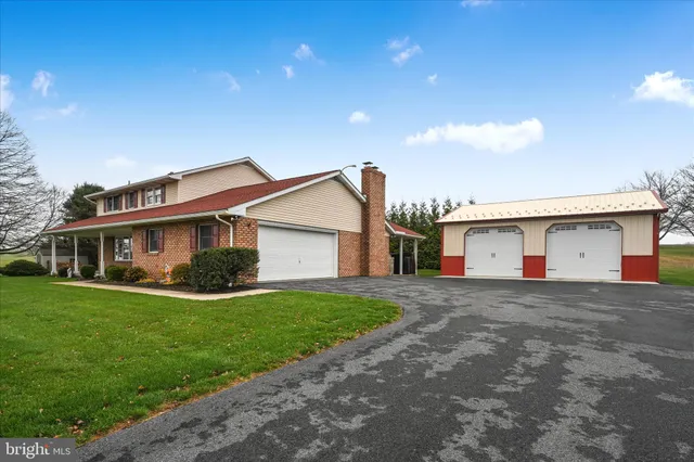a view of a house with a yard and garage