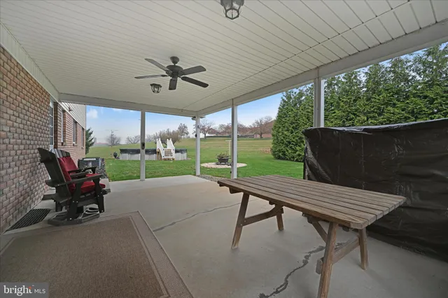 a view of a patio with a table chairs and a backyard