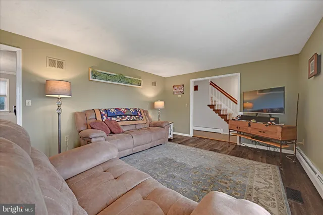 a living room with furniture and a lamp