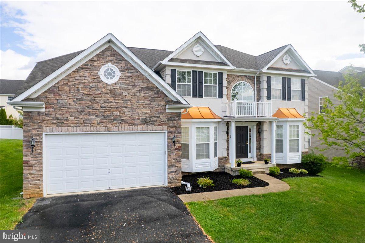 a front view of a house with a yard and garage