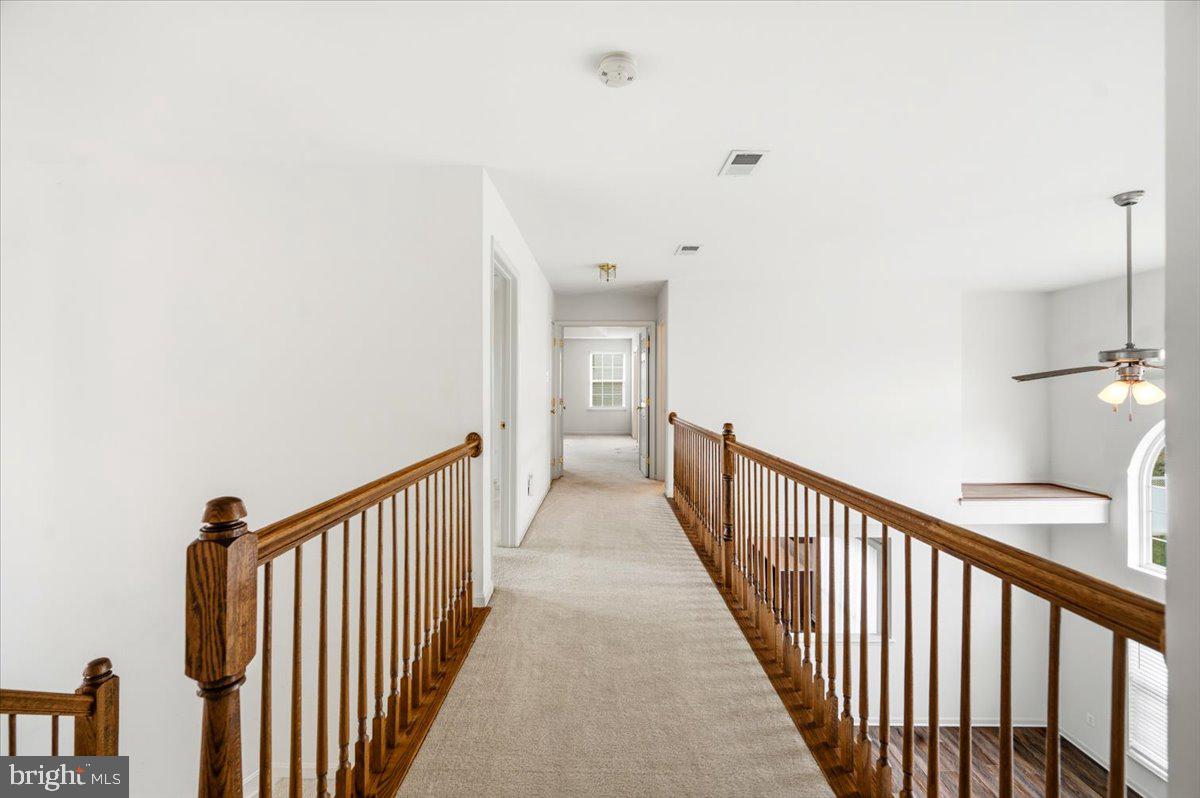 27 Sparkling Brook Road Ranson, WV 25438 - Photo 31 of 51 a view of a hallway with wooden floor and staircase