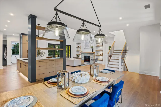 a view of a dining room with furniture a chandelier and wooden floor