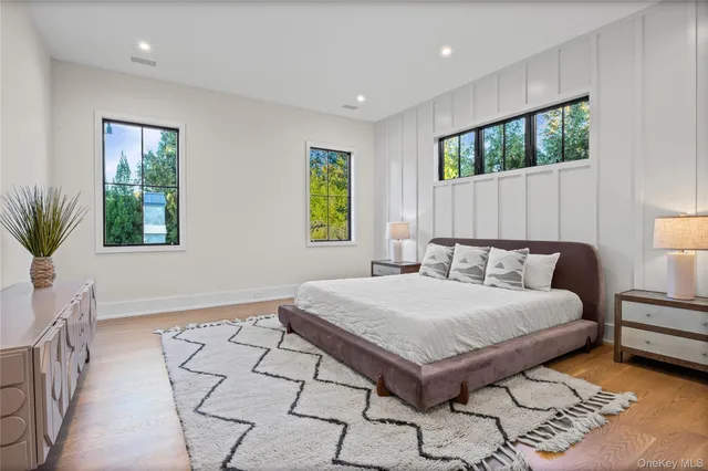 a bedroom with a large bed and a window