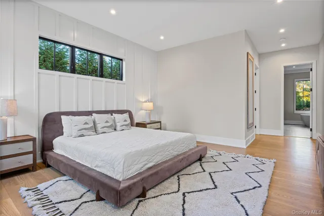 a bedroom with a large bed and a window