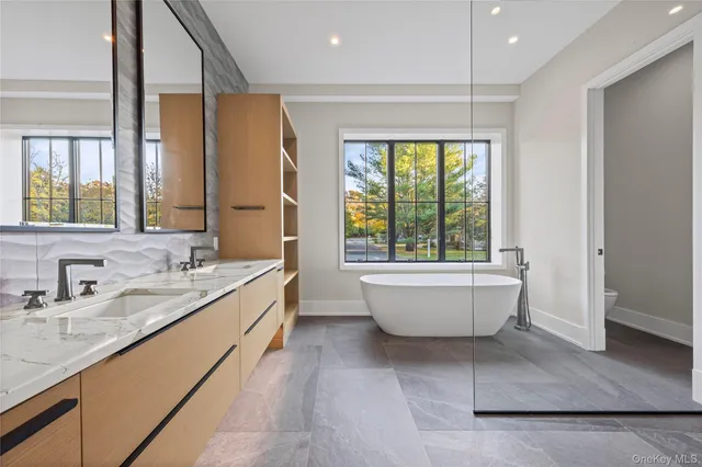 a bathroom with a large tub a vanity and a sink
