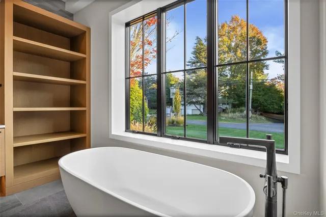 a white bath tub sitting next to a window