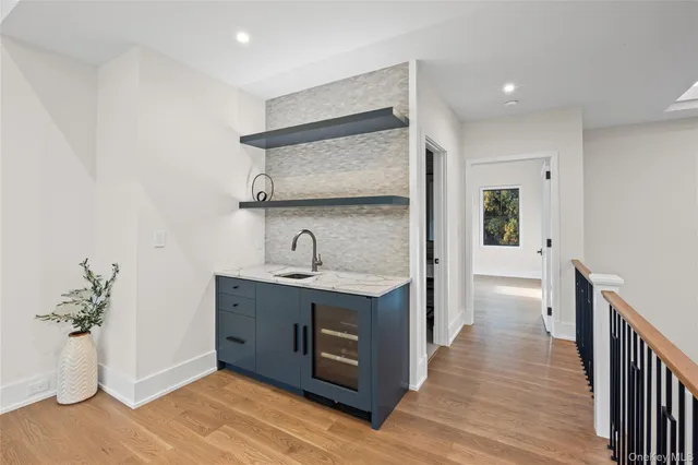 a view of a kitchen with a sink and wooden floor