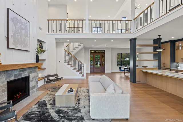 a living room with furniture a fireplace and a large window