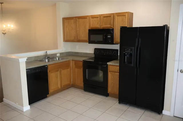a kitchen with a sink and a stove top oven