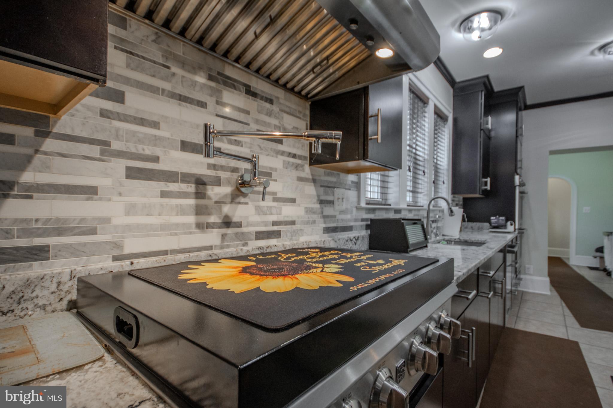 31008 Old Ocean City Road Salisbury, MD 21804 - Photo 22 of 65 a kitchen with a stove and a table
