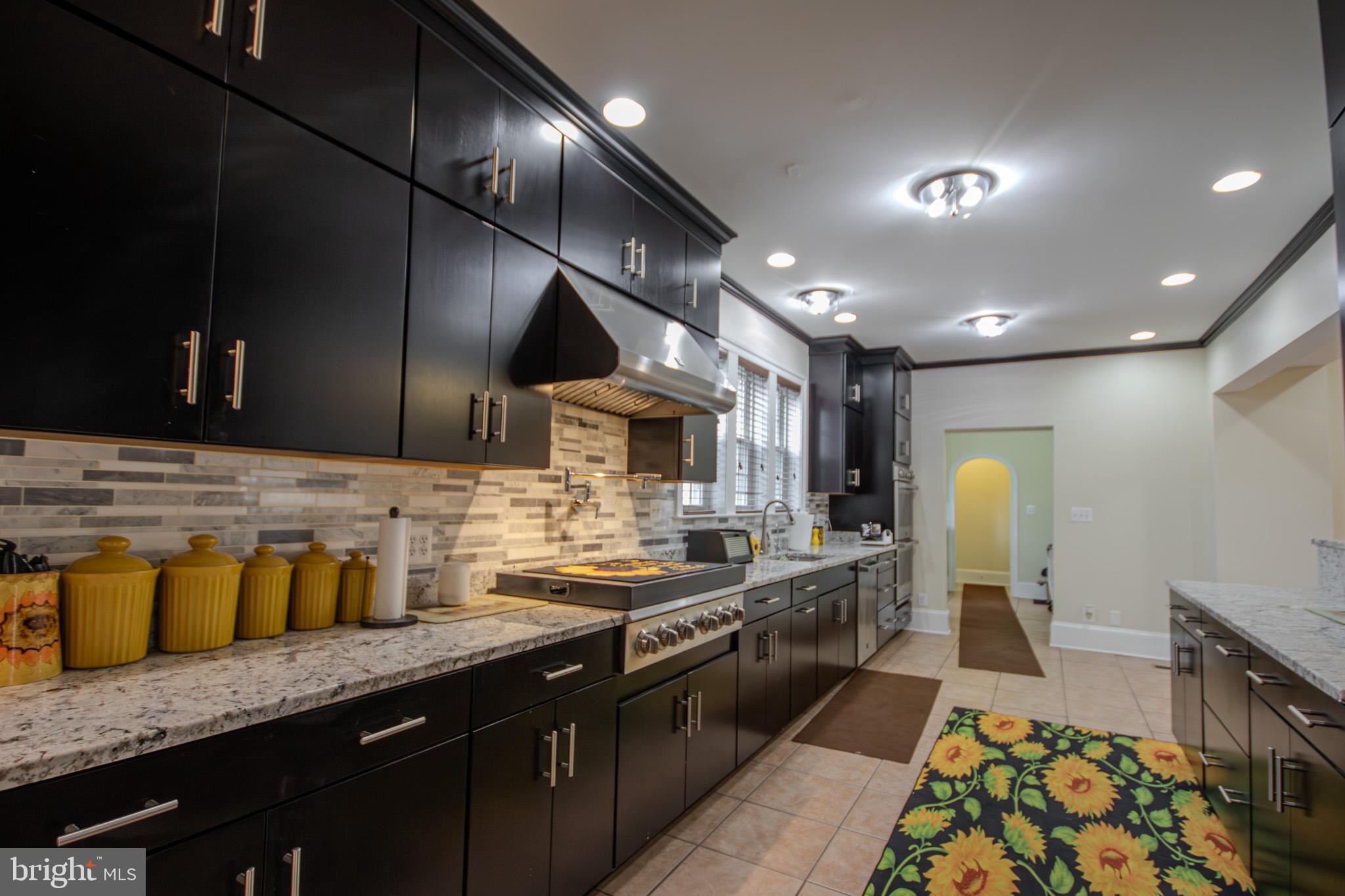 31008 Old Ocean City Road Salisbury, MD 21804 - Photo 24 of 65 a large kitchen with stainless steel appliances kitchen island granite countertop a sink and cabinets