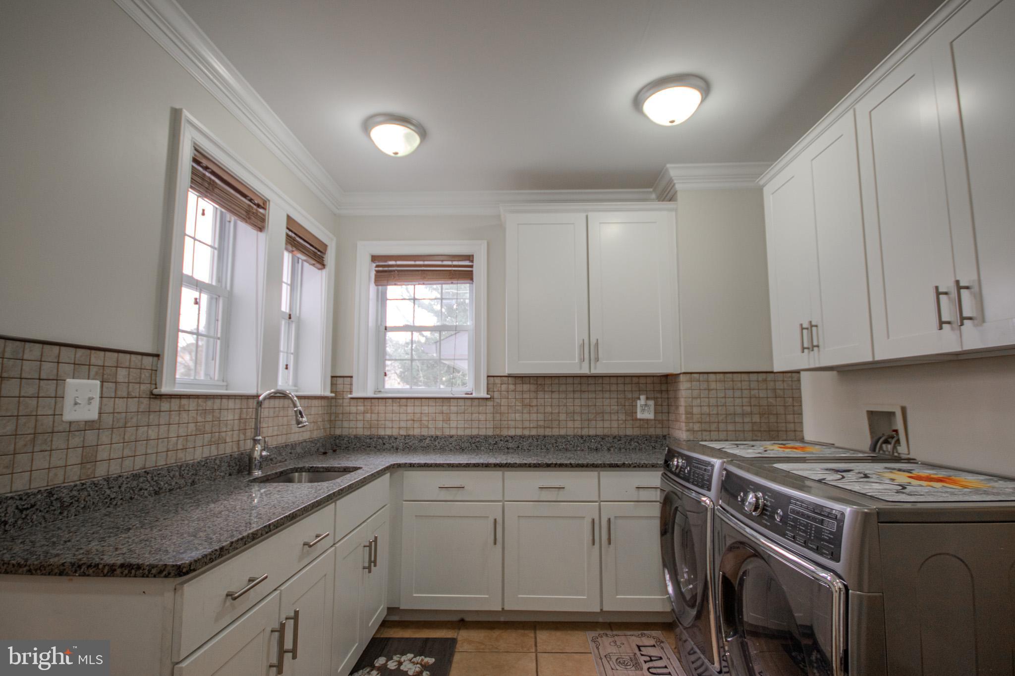 31008 Old Ocean City Road Salisbury, MD 21804 - Photo 26 of 65 a kitchen with granite countertop a sink stove and cabinets
