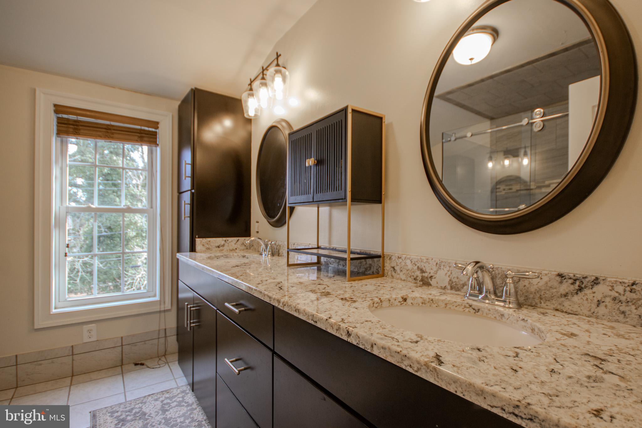 31008 Old Ocean City Road Salisbury, MD 21804 - Photo 46 of 65 a bathroom with a granite countertop double vanity sinks and a mirror