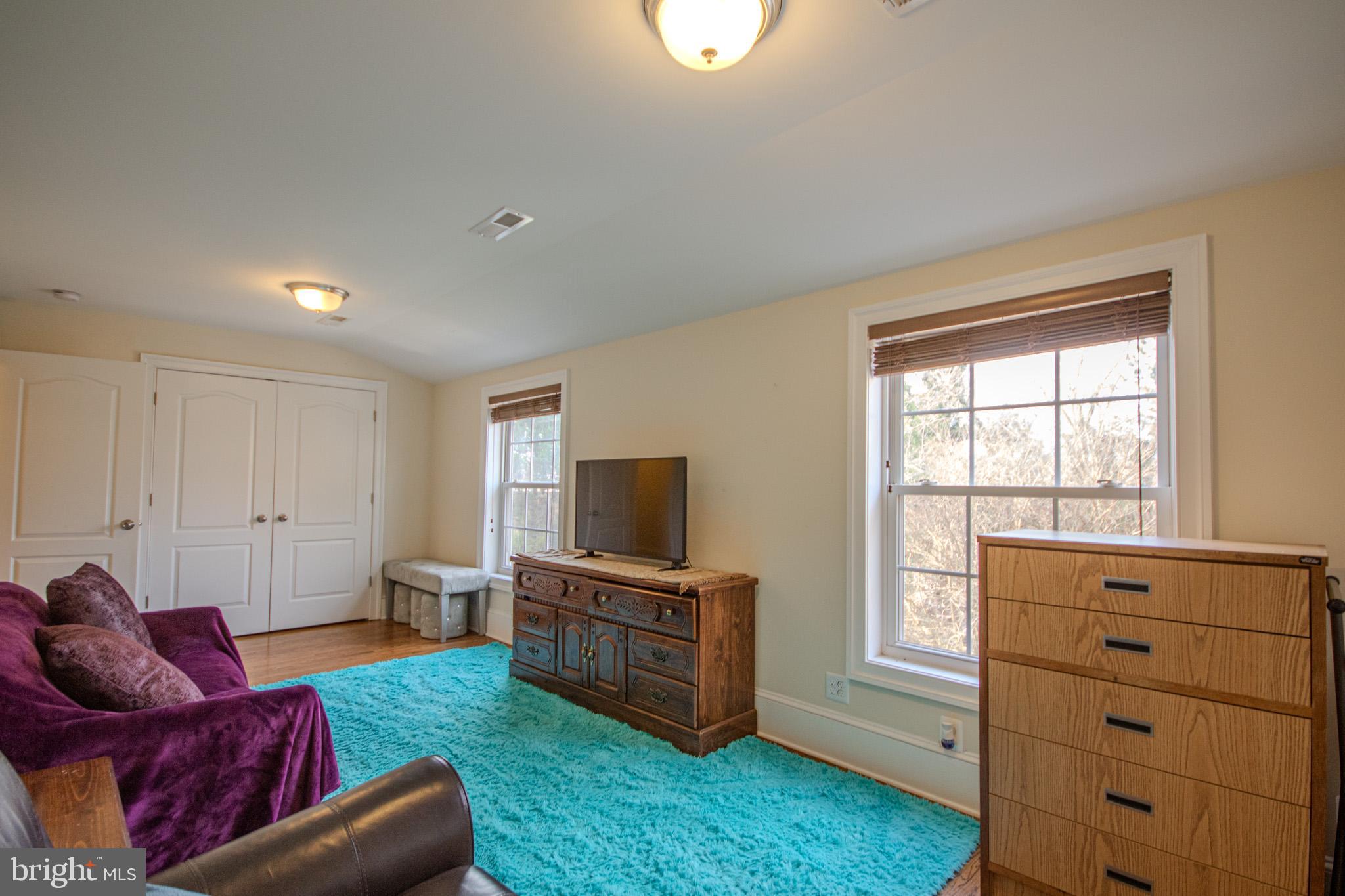 31008 Old Ocean City Road Salisbury, MD 21804 - Photo 49 of 65 a living room with furniture and a flat screen tv