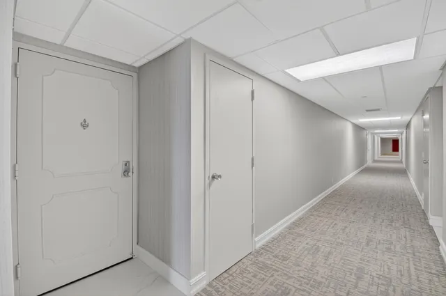 a living room with lots of furniture and a large window