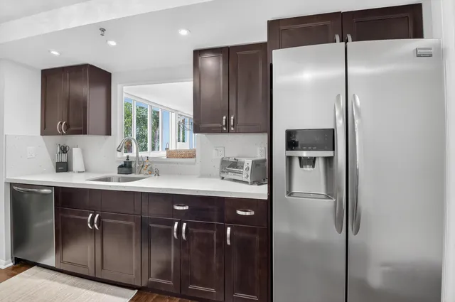 a bedroom with two beds and large windows
