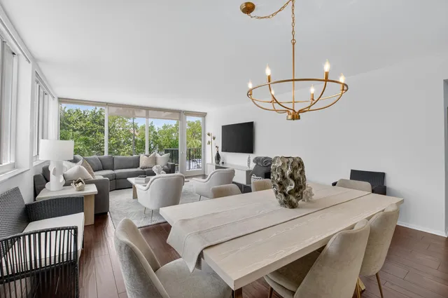a living room with furniture a large window and a flat screen tv