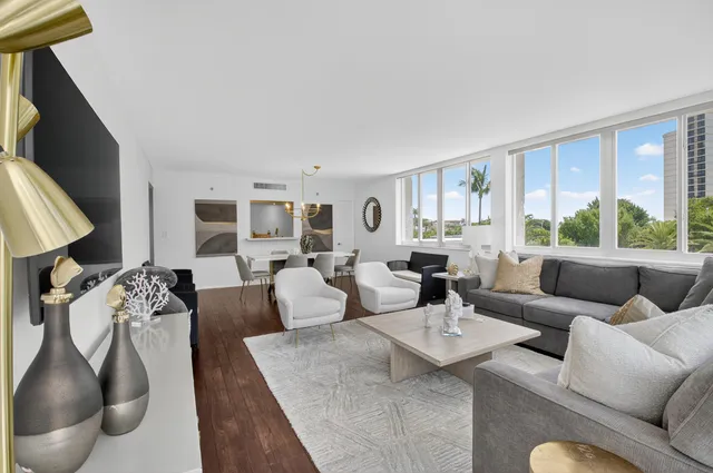 a kitchen with stainless steel appliances granite countertop a stove top oven a sink dishwasher and a refrigerator