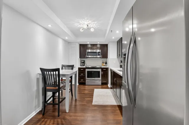 a kitchen with stainless steel appliances a sink stove and cabinets
