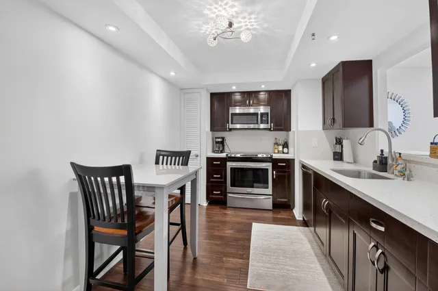 a kitchen with a refrigerator and a sink