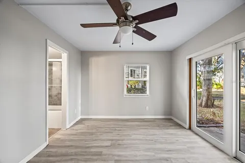 a view of empty room with wooden floor