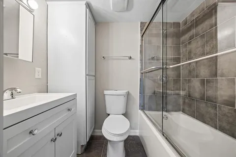 a bathroom with a toilet sink and mirror