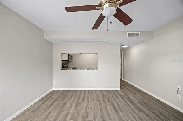 a view of empty room with wooden floor