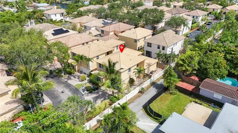 an aerial view of a house with swimming pool and outdoor space