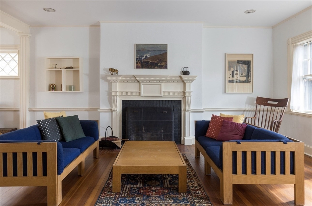 63 Griggs Road Brookline, MA 02446 - Photo 2 of 12 a bedroom with furniture and a fireplace