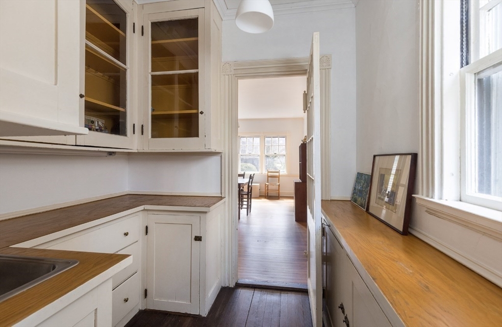 63 Griggs Road Brookline, MA 02446 - Photo 8 of 12 a view of a kitchen with furniture and wooden floor