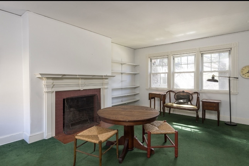 63 Griggs Road Brookline, MA 02446 - Photo 9 of 12 a living room with furniture and a fireplace