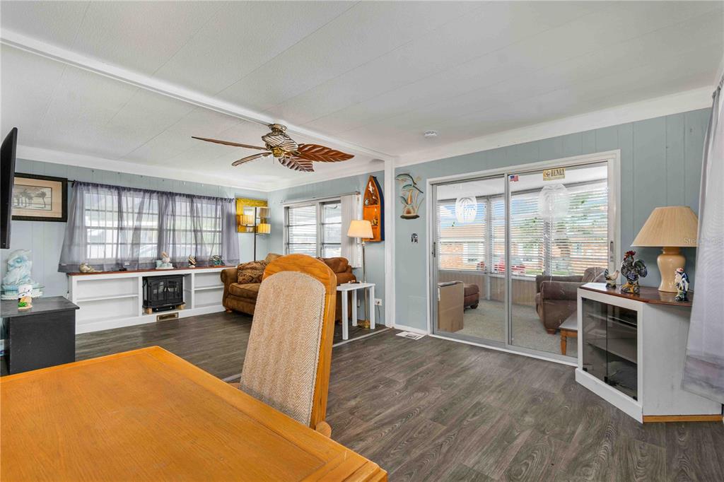 10399 67th Avenue North, Unit 4 St. Petersburg, FL 33708 - Photo 12 of 35 a living room with furniture a flat screen tv and a large window