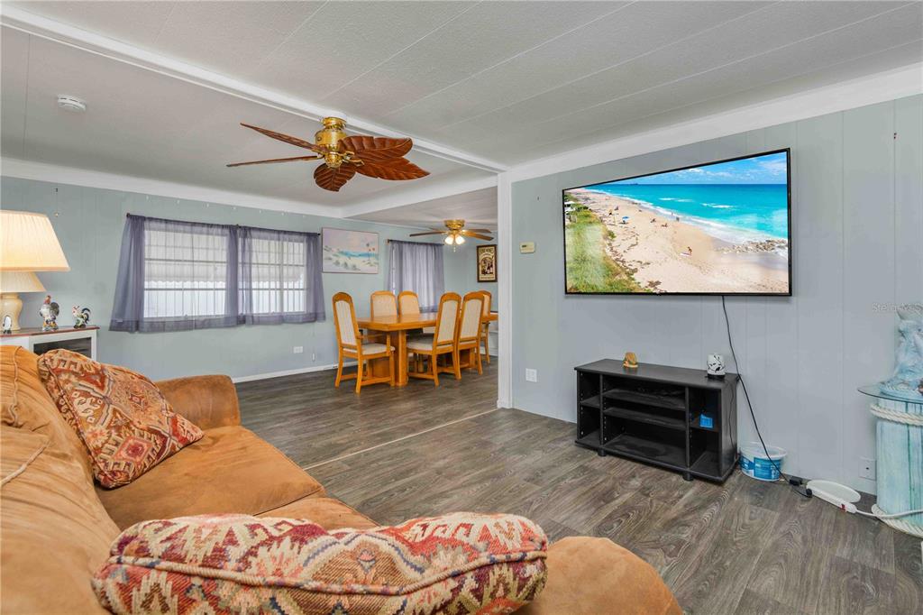 10399 67th Avenue North, Unit 4 St. Petersburg, FL 33708 - Photo 14 of 35 a living room with furniture and a flat screen tv