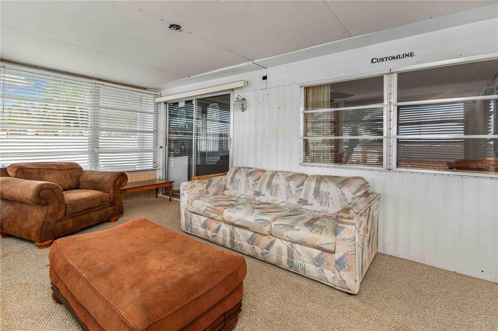 10399 67th Avenue North, Unit 4 St. Petersburg, FL 33708 - Photo 15 of 35 a living room with furniture and windows