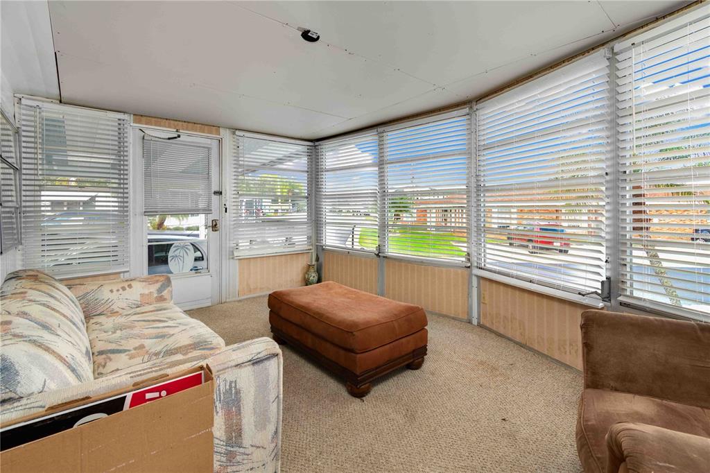 10399 67th Avenue North, Unit 4 St. Petersburg, FL 33708 - Photo 16 of 35 a living room with furniture and a large window