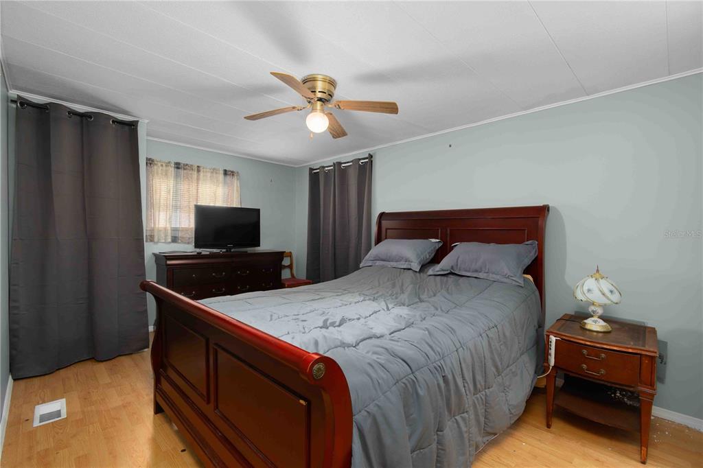 10399 67th Avenue North, Unit 4 St. Petersburg, FL 33708 - Photo 17 of 35 a bedroom with a bed and a flat screen tv