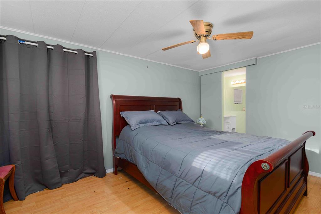 10399 67th Avenue North, Unit 4 St. Petersburg, FL 33708 - Photo 18 of 35 a bedroom with a bed and a chandelier