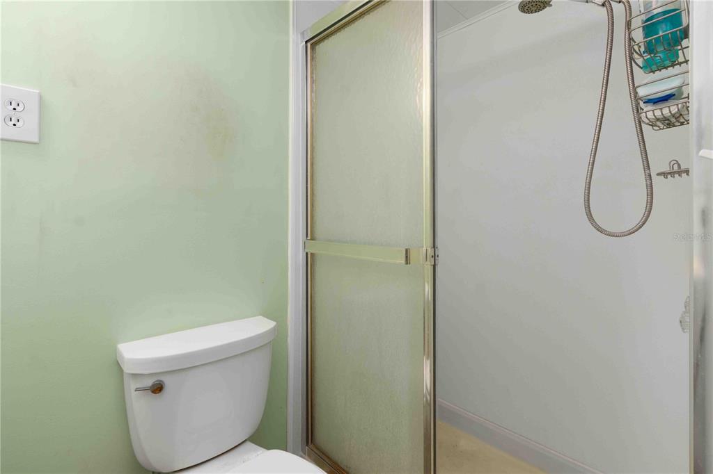 10399 67th Avenue North, Unit 4 St. Petersburg, FL 33708 - Photo 20 of 35 a white toilet sitting next to a shower