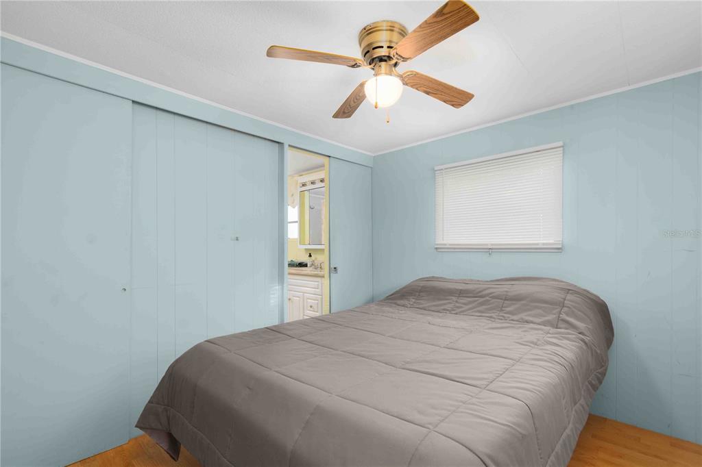 10399 67th Avenue North, Unit 4 St. Petersburg, FL 33708 - Photo 22 of 35 a bedroom with a bed and a window