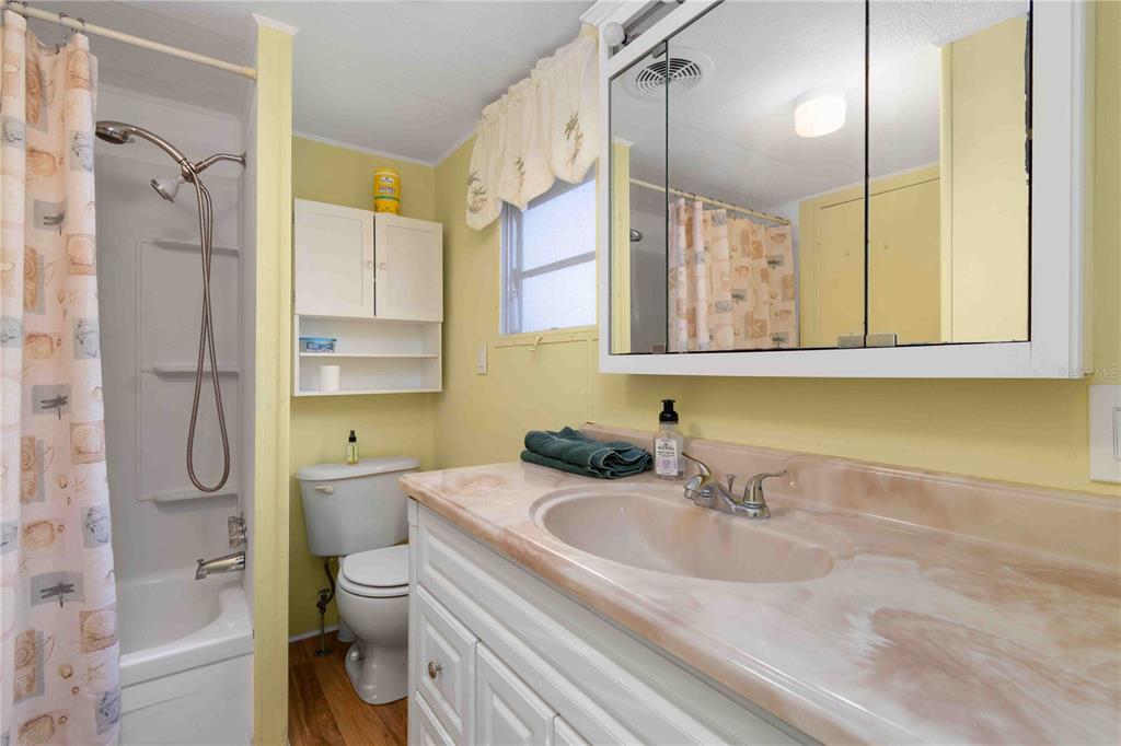 10399 67th Avenue North, Unit 4 St. Petersburg, FL 33708 - Photo 23 of 35 a bathroom with a sink a toilet and shower