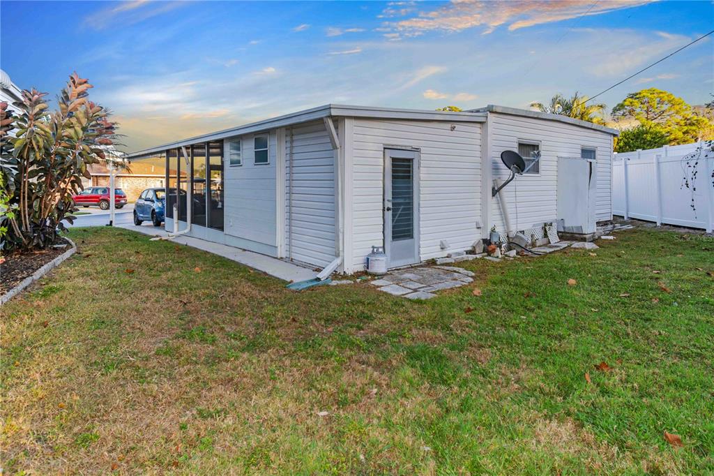 10399 67th Avenue North, Unit 4 St. Petersburg, FL 33708 - Photo 28 of 35 front view of a house with a yard