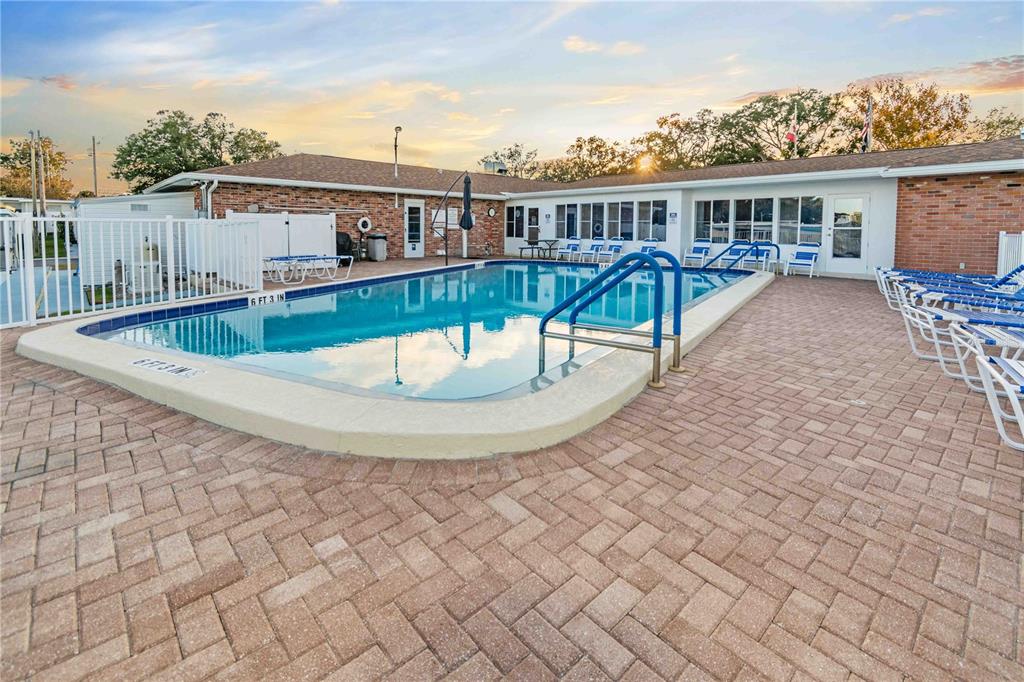 10399 67th Avenue North, Unit 4 St. Petersburg, FL 33708 - Photo 34 of 35 an aerial view of a house with a swimming pool